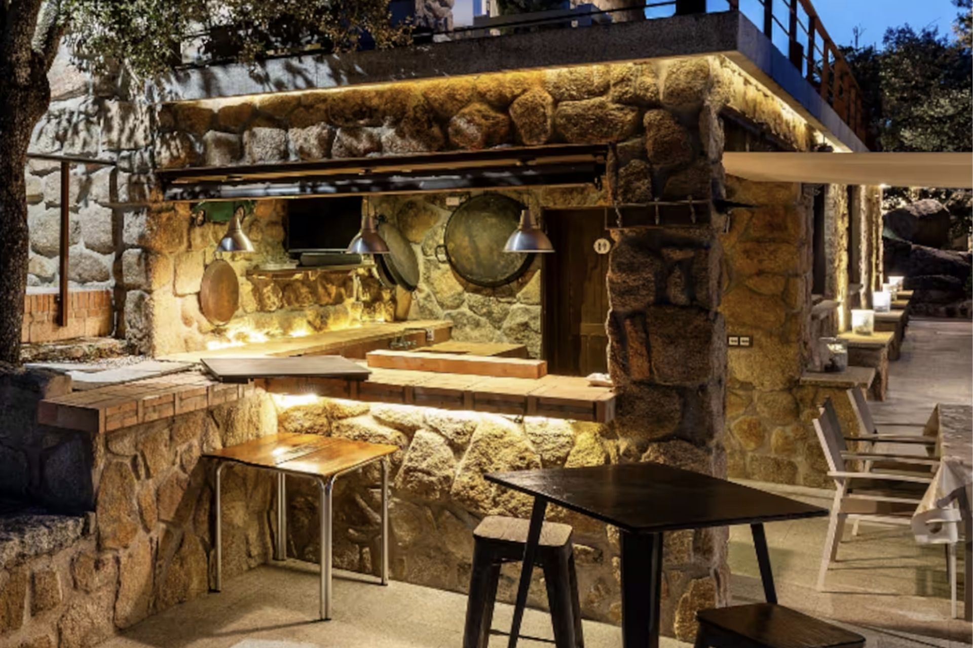 Cocina exterior de piedra iluminada